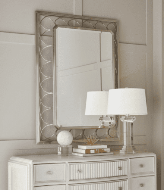 Elegant mirror above white dresser