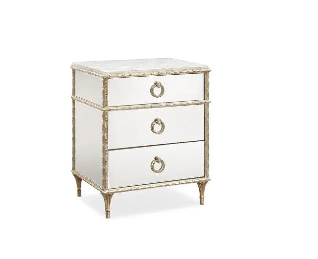 Mirrored three-drawer nightstand with gold accents.