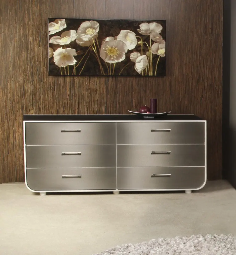 Stylish dresser beneath flower painting