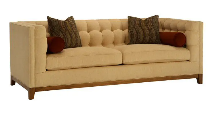 Beige tufted sofa with decorative pillows