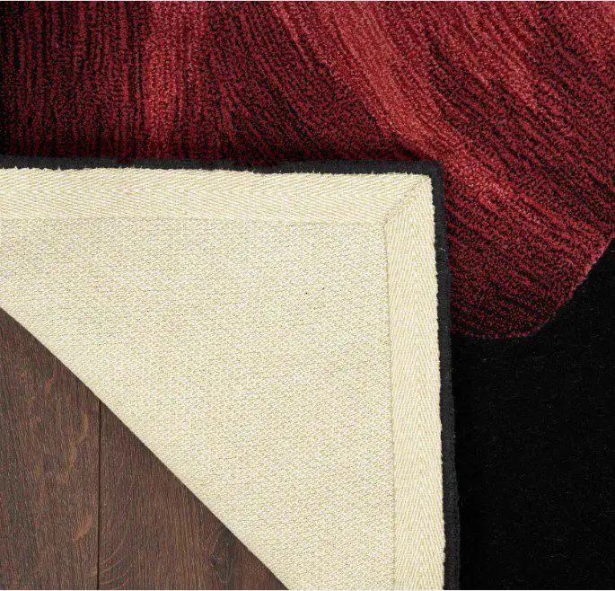 Corner of a red rug flipped over