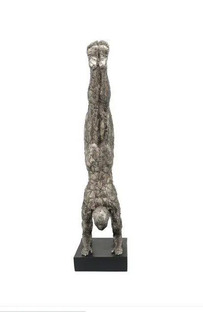 Sculpture of person in handstand pose