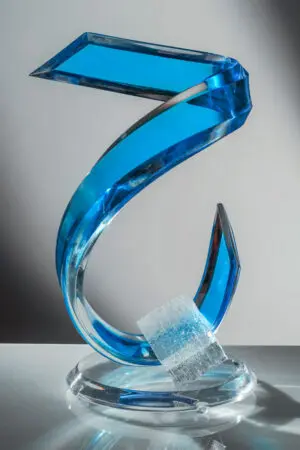 Curved blue glass sculpture with base